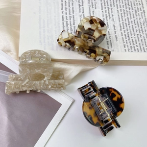 Three-piece geometric acetate hair claw clips with elegant marble and tortoiseshell patterns