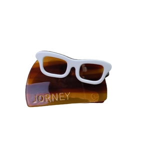 Chic tortoiseshell acetate hair claw clip featuring a unique white eyeglass shape design