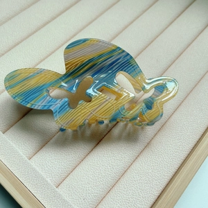 Pince à cheveux papillon élégante aux rayures marbrées bleues et jaunes, fini brillant
