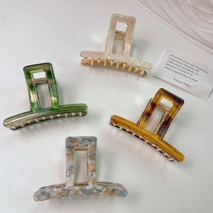 Elegant rectangle acetate claw clips in marble and tortoiseshell patterns with gold spring