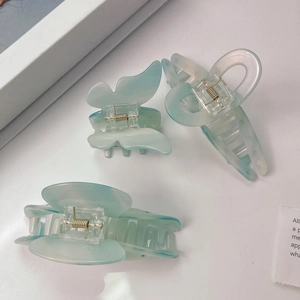 Three-piece light blue acetate hair claw clip set with butterfly and geometric designs