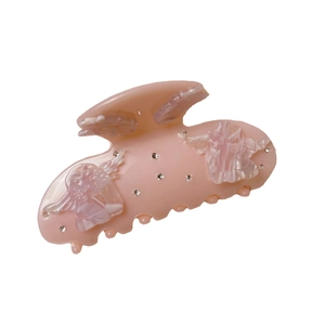 Pink acetate hair claw clip with cherub reliefs and rhinestones on a white background