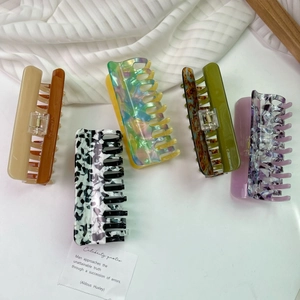 Five assorted large acetate hair claws in vintage oil painting colors with a glossy finish
