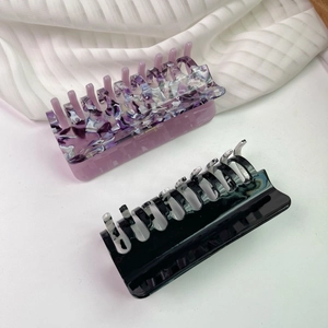 Detail of large acetate hair claws with marble texture and strong grip for thick hair