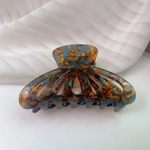 Macro detail of French vintage amber and peacock blue acetate hair claw clip