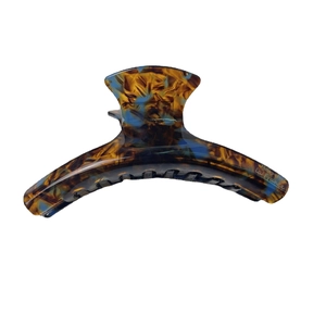 Large acetate hair claw clip with tortoise pattern and La France logo on white background