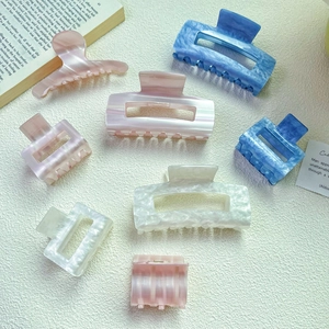 Elegant marble acetate hair claws in pastel pink and sea blue for sweet Korean hair styling