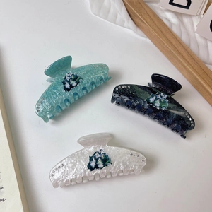 Detailed set of three marble acetate cat hair claws with shimmering rhinestone accents