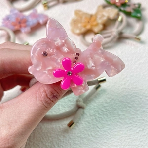 Elastisches Haargummi mit rosa Acryl-Hundeanhänger, Blumendetails und funkelnden Steinen