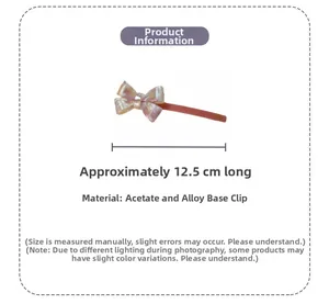 Detail view of pink bow hair clip showing 12.5cm length and acetate texture
