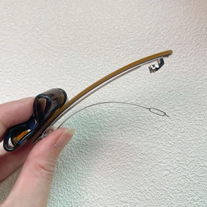 Close-up of a tortoiseshell acetate bow hair clip with a durable silver metal spring