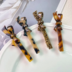 Set of four elegant acetate bow hair clips with faux tortoiseshell and leopard patterns