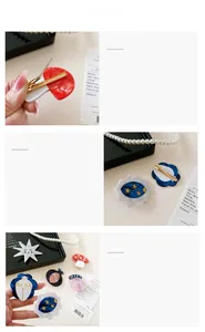 Detail showing acetate hair clips with artistic oil painting patterns and golden alloy clips