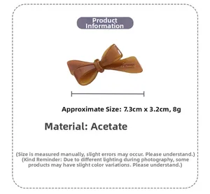 Detailed view of brown acetate bow hair clip with size dimensions 7.3cm and 8g weight