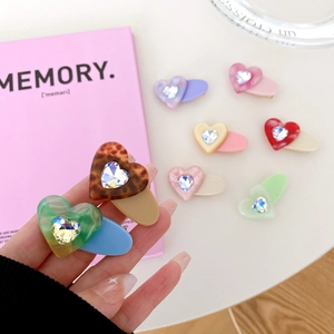 Elegant acetate heart hair clips with sparkling crystals in assorted marble patterns