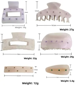 Detail view of acetate hair claws and clips with rhinestone accents in various sizes