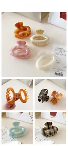 Macro detail of striped acetate hair claws in various colors with France Handmade text