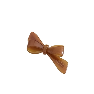 Elegant amber acetate bow hair clip with polished finish and French style engraving
