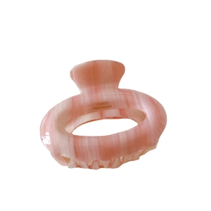 Pink marbled acetate hair claw clip with France Handmade logo on white background