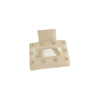 Elegant cream rectangular acetate hair claw clip with colorful rhinestones on white background