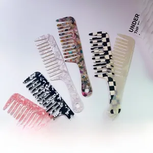 Detail of five acetate wide-tooth hair combs with marble patterns and glossy finish