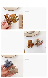 Detailed macro view of tortoise shell acetate hair claws with gold Barrette La France text