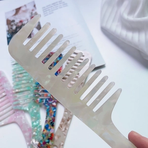 Detailed macro view showing diverse marble textures and colors of acetate hair combs