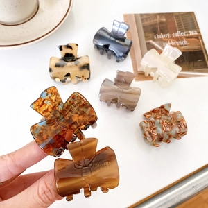 Selection of acetate claw clips in marble and tortoiseshell patterns with French branding