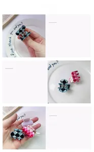 Detail of mini checkered hair claws in navy, pink, and lavender acetate resin material