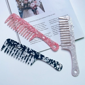 Acetate wide-tooth hair comb with marble patterns and geometric handle for detangling