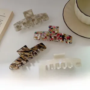 Detailed macro view of acetate hair claws in marble and tortoiseshell patterns