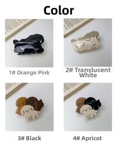 Detailopname van vier verschillende kleuren puppyvormige haarklemmen van acetaat