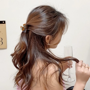 Elegant tortoise shell acetate bow hair claw clip for a chic half-up hairstyle
