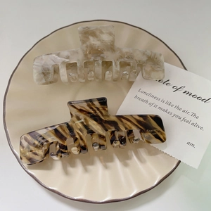 Elegant large acetate hair claws with marble and tortoiseshell patterns for women