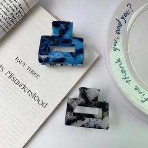 Elegant square acetate claw clips with blue and black ink marble texture patterns
