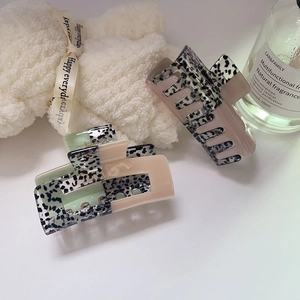 Korean retro acetate hair claw clips in pink and mint green with cow print patterns