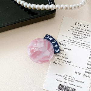 Pink marble acetate hair clip with blue crescent moon and white star pattern