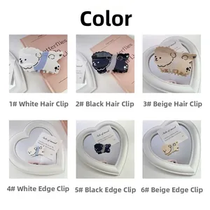Vue détaillée des pinces à cheveux chien Teddy en blanc, noir et couleurs beige