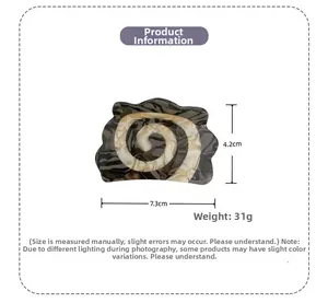 Detail showing marble textured acetate hair claw clip dimensions 7.3cm length and 4.2cm height