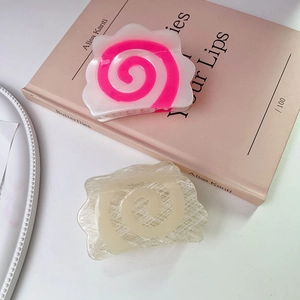 Creative narutomaki fish cake hair claws with pink spiral patterns on white acrylic base