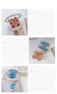 Detail shot of heart-shaped acetate hair claws with sparkling rhinestones in soft pastel colors