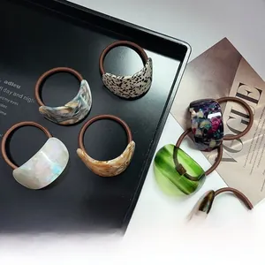 Detailed set of premium acetate hair ties featuring leopard and marble patterns