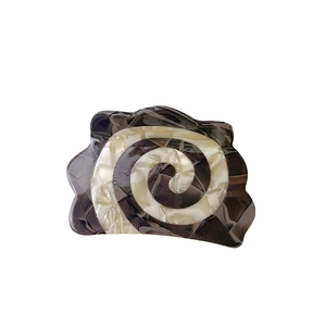 Brown and white marble pattern acetate claw clip with irregular wavy shell shape