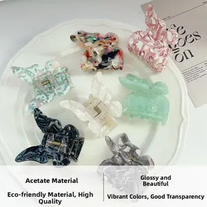 Detailed top view of 7 colorful acetate butterfly hair clips displayed on a white plate