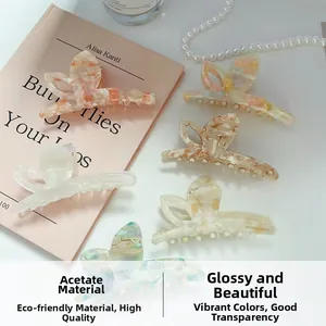 Detailed close-up of six colorful acetate butterfly hair claws with elegant marble textures