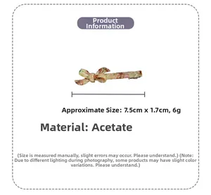 Detail view of acetate bow hair clip showing dimensions of 7.5cm by 1.7cm in marble finish