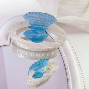 Elegant set of two blue diamond acetate hair claws with marble finish on mirror