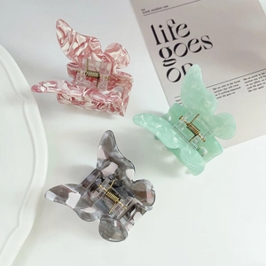 Three-piece butterfly hair claws set with elegant marble texture in pink, green, and black