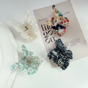 Elegant butterfly acetate hair claws in four colors like marble and floral patterns