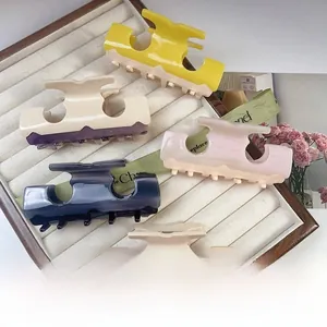 Macro detail of assorted high-quality acetate hair claws in five elegant marble colors